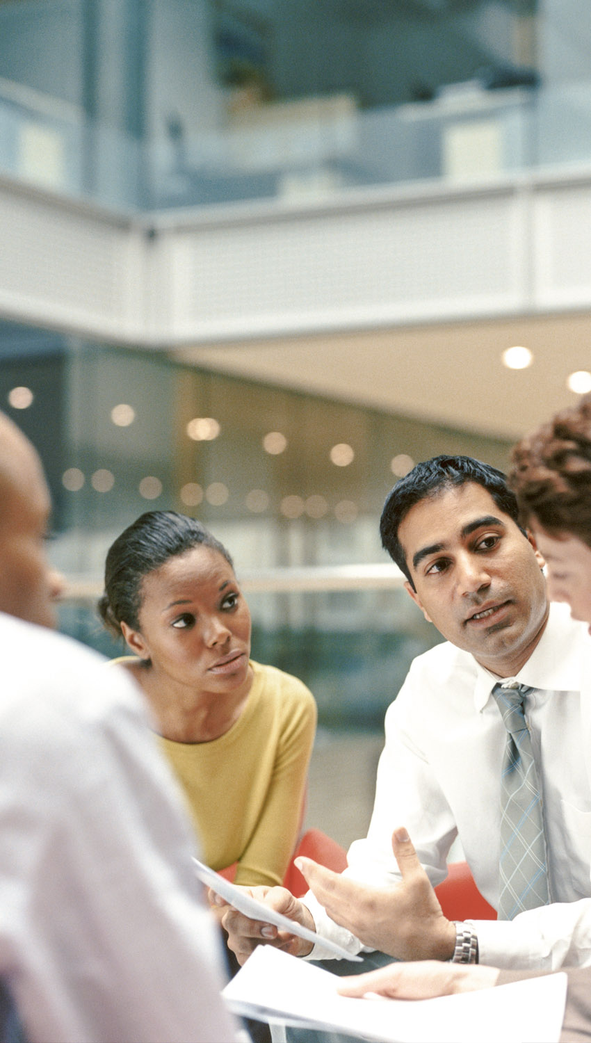 Business People Sitting in an Office Building Having a Meeting